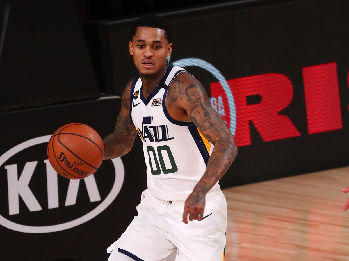Utah Jazz guard Jordan Clarkson (00) brings the ball up court against Denver Nuggets center Nikola Jokic (15) during the first half of game seven of the first round of the 2020 NBA Playoffs